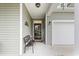 Cozy front porch featuring a welcoming bench, decorative accents, and covered entry adjacent to the garage at 129 Astoria Park Loop, Conway, SC 29526
