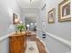 Bright hallway features wood floors, neutral walls with molding, console table, and framed art at 129 Astoria Park Loop, Conway, SC 29526