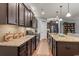 Open kitchen with granite countertops, stainless appliances and dark wood cabinetry at 129 Astoria Park Loop, Conway, SC 29526