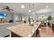 Kitchen featuring granite countertop island with sink and seating open to living and dining at 129 Astoria Park Loop, Conway, SC 29526