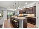 Charming kitchen with dark wood cabinets, granite countertops, and stainless steel appliances at 129 Astoria Park Loop, Conway, SC 29526