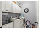 Functional laundry room equipped with front load washer and dryer and ample overhead storage at 129 Astoria Park Loop, Conway, SC 29526