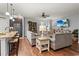 Open living room with kitchen island, adjacent dining area, and plenty of natural light at 129 Astoria Park Loop, Conway, SC 29526