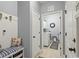 Well-organized mudroom with bench seating, coat hooks, and access to laundry area with washer and dryer at 129 Astoria Park Loop, Conway, SC 29526