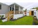 Lush backyard featuring a covered patio, storage shed, and well-maintained lawn, ideal for outdoor living and storage at 1525 Capella Ln., Myrtle Beach, SC 29575