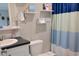 Bathroom with a white vanity, toilet, and a blue and white shower curtain at 1525 Capella Ln., Myrtle Beach, SC 29575