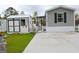 Attractive mobile home features a tidy driveway, storage shed, and well-kept yard creating great curb appeal at 1525 Capella Ln., Myrtle Beach, SC 29575