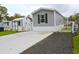 Well-maintained mobile home featuring a storage shed and paved driveway, offering a comfortable and inviting exterior at 1525 Capella Ln., Myrtle Beach, SC 29575