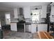 Well-lit kitchen with stainless steel appliances, white cabinets, and wood countertops at 1525 Capella Ln., Myrtle Beach, SC 29575