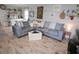 Charming living room featuring a comfortable sectional, wood floors, and a well-lit space at 1525 Capella Ln., Myrtle Beach, SC 29575