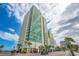 Modern condo building with vibrant green glass, offering a contemporary design and a desirable location near the beach at 201 S Ocean Blvd. # 1812, Myrtle Beach, SC 29577