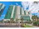 Stunning high-rise condo building featuring modern architecture, lush landscaping, and a prime oceanfront location at 201 S Ocean Blvd. # 1812, Myrtle Beach, SC 29577
