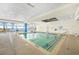 Bright indoor pool area with large windows and tiled deck at 201 S Ocean Blvd. # 1812, Myrtle Beach, SC 29577