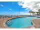 Outdoor pool with beach views, surrounded by lounge chairs and palm trees at 201 S Ocean Blvd. # 1812, Myrtle Beach, SC 29577