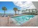 Outdoor pool area with brick patio, palm trees, and lounge chairs at 201 S Ocean Blvd. # 1812, Myrtle Beach, SC 29577