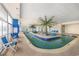 Indoor pool area featuring palm trees and lounge chairs at 201 S Ocean Blvd. # 1812, Myrtle Beach, SC 29577
