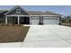 Charming home exterior features a two-car garage, gray siding, and a well-manicured lawn at 242 River Edge Dr., Myrtle Beach, SC 29588
