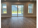 Bright living room with hardwood floors and natural light coming from the patio doors at 242 River Edge Dr., Myrtle Beach, SC 29588