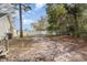 Large backyard with white fence and mature trees offering plenty of space for outdoor activities at 550 Crusade Circle, Conway, SC 29526