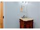Vintage vanity with marble sink, dark wood cabinetry, and neutral walls at 67 Kingsbury Pl., Georgetown, SC 29440