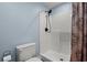 Bathroom with white tiled shower stall, patterned shower curtain, and toilet at 67 Kingsbury Pl., Georgetown, SC 29440