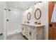 Elegant bathroom with double vanity, ornate mirrors, wood floors, and walk-in shower at 67 Kingsbury Pl., Georgetown, SC 29440