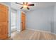 Neutral-toned bedroom with wood-look floors, doors, and bright natural light at 67 Kingsbury Pl., Georgetown, SC 29440