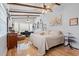 Spacious bedroom featuring hardwood floors, ceiling fan, and lots of natural light from large windows at 67 Kingsbury Pl., Georgetown, SC 29440