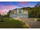 Charming two-story home with a spacious driveway and two-car garage at dusk at 67 Kingsbury Pl., Georgetown, SC 29440