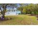 Two-story home featuring a well-manicured front yard, ample parking, and a pool in the backyard at 67 Kingsbury Pl., Georgetown, SC 29440