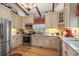 Modern kitchen boasts white cabinets, stainless steel appliances, stone backsplash, and granite counters at 67 Kingsbury Pl., Georgetown, SC 29440