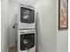 Modern, stacked washer and dryer in laundry area for space-saving efficiency at 67 Kingsbury Pl., Georgetown, SC 29440