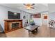 Inviting living room featuring a stone fireplace, ceiling fan, and wood-look floors at 67 Kingsbury Pl., Georgetown, SC 29440