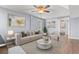 Staged living room with neutral sofa, patterned rug, and a round marble coffee table at 67 Kingsbury Pl., Georgetown, SC 29440