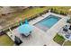 Inviting pool area with a lounge area, complete with an umbrella, table and chairs, and a well-maintained yard at 67 Kingsbury Pl., Georgetown, SC 29440