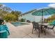 A backyard pool and patio create an ideal relaxation area for outdoor enjoyment with a shade umbrella at 67 Kingsbury Pl., Georgetown, SC 29440