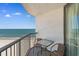 Condo balcony with ocean view, featuring table and chairs for relaxing by the sea at 9550 Shore Dr. # 1026, Myrtle Beach, SC 29572