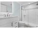 Bright bathroom featuring white cabinets, marble countertops, and tiled walk-in shower with glass door at 9550 Shore Dr. # 1026, Myrtle Beach, SC 29572