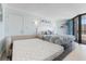 Bright beach themed bedroom has balcony access, a sofa, and a queen bed with a pull out bed at 9550 Shore Dr. # 1026, Myrtle Beach, SC 29572