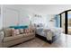 Bright beach themed bedroom has balcony access, a sofa and a queen bed at 9550 Shore Dr. # 1026, Myrtle Beach, SC 29572