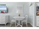 Bright dining area featuring a white table set for two, with coastal-themed décor and a TV at 9550 Shore Dr. # 1026, Myrtle Beach, SC 29572