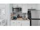 Efficient kitchenette featuring stainless steel appliances, mosaic backsplash, and granite counters at 9550 Shore Dr. # 1026, Myrtle Beach, SC 29572