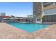 Outdoor pool area featuring lounge chairs and umbrellas in front of a high-rise building at 9550 Shore Dr. # 1026, Myrtle Beach, SC 29572