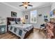Comfortable bedroom featuring a ceiling fan, wood floors, and a dresser with a TV at 1000 Oak Marsh Ln., North Myrtle Beach, SC 29582