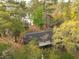 Aerial view shows home nestled in trees near water featuring the roof needing replacement at 1030 Waccamaw Lake Dr., Conway, SC 29526