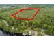 Aerial view of a wooded property with a waterway, outlined in red at 1030 Waccamaw Lake Dr., Conway, SC 29526