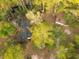 Aerial view of a cozy home nestled within a lush, green forest with a black shingle roof needing replacement at 1030 Waccamaw Lake Dr., Conway, SC 29526