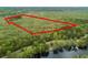 Aerial view of a wooded property with a waterfront, outlined in red at 1030 Waccamaw Lake Dr., Conway, SC 29526