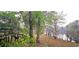 A treed backyard with a deck and a view of the lake, highlighting the natural beauty of the property at 1030 Waccamaw Lake Dr., Conway, SC 29526