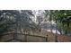 A wood deck overlooking a serene lake surrounded by moss-draped trees, creating a peaceful outdoor space at 1030 Waccamaw Lake Dr., Conway, SC 29526